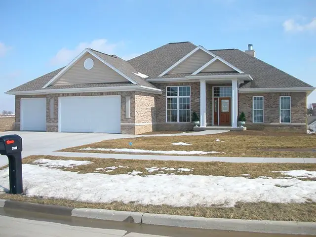 Finished home with brick front, three-car garage and driveway