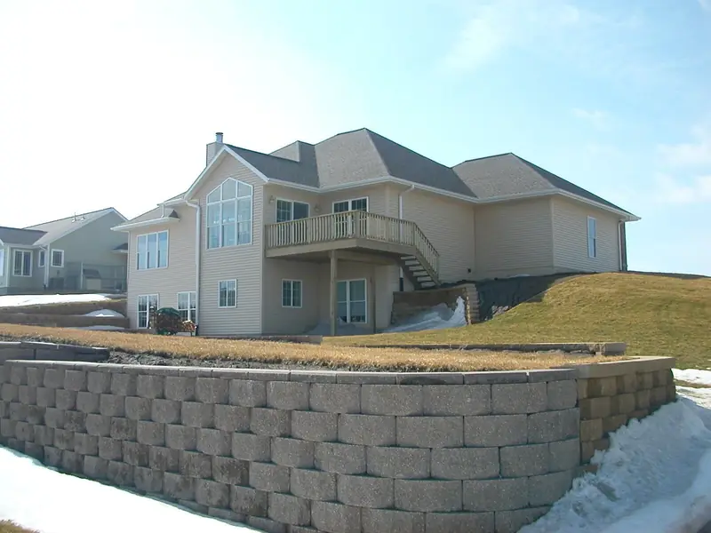 Finished walkout home above a block retaining wall
