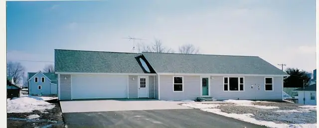 Finished ranch home and driveway in winter