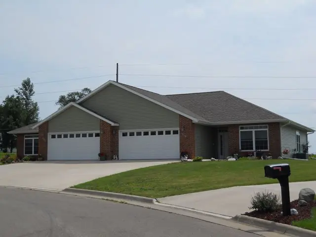 Finished ranch home with three-car garage and concrete driveway