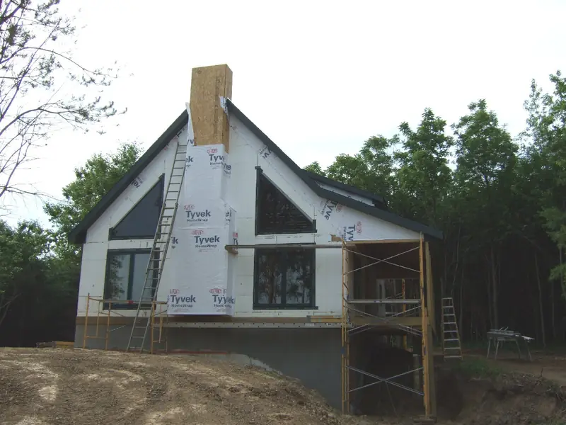 ICF home with stone chimney under construction