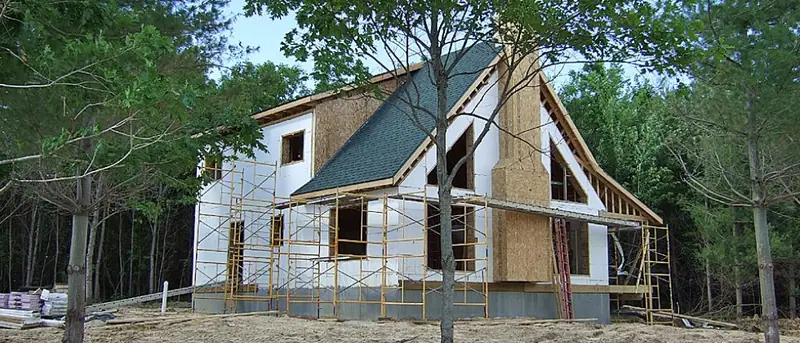 Two-story ICF home under construction in the trees