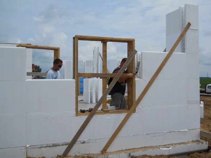 Crew setting a window buck in a tall ICF wall